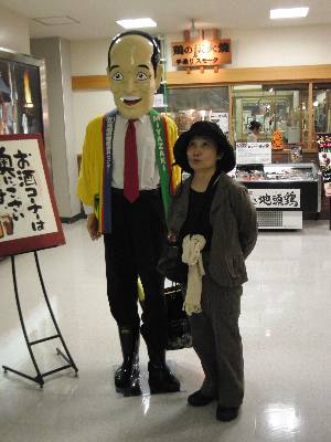 これまた全然似てない宮崎空港にある東国原知事の人形と記念写真を撮る母